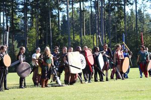 A fighting line of monsters. The sun shines in their eyes harshly.