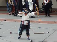 Marus at Wolfpack Opener with a drawn bow and oversized helmet